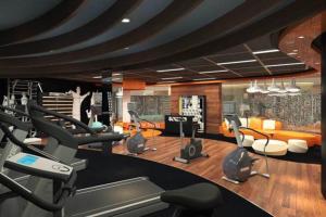 a gym with treadmills and elliptical machines at Villa Little Ubud in Gadok 1