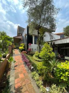 a house with a walkway in front of a yard at Villa Little Ubud in Gadok 1