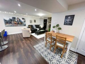 a living room with a table and a couch at Spacious & Renovated 1BD Suite w/parking in Toronto