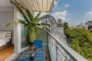a balcony with a view of a building at Cheers Hostel Hanoi in Hanoi