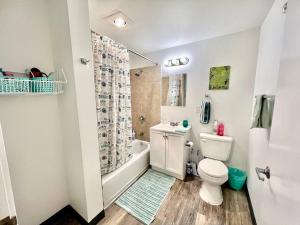 a white bathroom with a toilet and a shower at Apartment Studio with Shared Bathroom on the 1st Floor 10 minutes walk to University of WA in Seattle