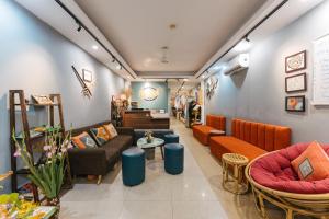 a waiting room with couches and chairs in a store at Cheers Hostel Hanoi in Hanoi