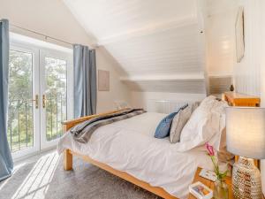 una camera con un letto e una grande finestra di Bwlch Farm Lodge a Briton Ferry