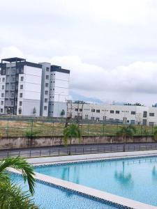 a large swimming pool in front of a building at 3 Bedroom Apartment with Pool and Beautiful View in Klebang, Ipoh in Chemor
