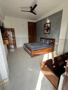 a bedroom with two beds and a ceiling fan at Lalita Kunj - Fully furnished Appartment Vrindavan in Vrindāvan