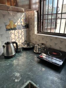 a kitchen counter with a tea kettle on a stove at Lalita Kunj - Fully furnished Appartment Vrindavan in Vrindāvan