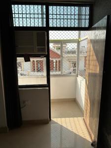 an open door to a room with a window at Lalita Kunj - Fully furnished Appartment Vrindavan in Vrindāvan