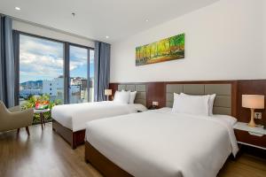 Giường trong phòng chung tại Aria Grand Hotel & Spa