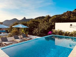 a swimming pool on the roof of a house at Tatala Hotel & Garden in Tepoztlán