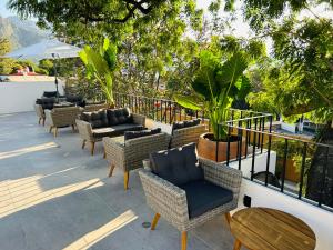 a group of chairs and tables on a patio at Tatala Hotel & Garden in Tepoztlán