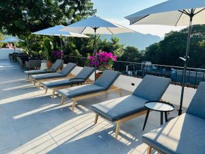 a row of chairs and umbrellas on a roof at Tatala Hotel & Garden in Tepoztlán