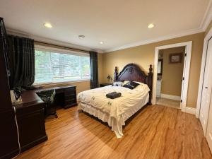 a bedroom with a bed and a large window at Vancouver Luxury Homestay in Richmond