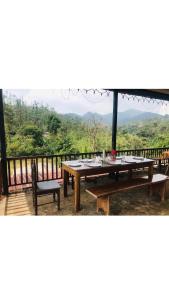 a picnic table with a view of the mountains at Jungle view home stay in Madikeri