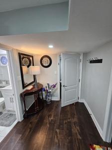 a hallway with a door and a table with a lamp at Exclusive 2 BR Furnished Apartment in Milton Ontario Canada in Milton