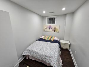 a small bedroom with a bed and a window at Exclusive 2 BR Furnished Apartment in Milton Ontario Canada in Milton