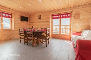 a dining room with a table and chairs in a cabin at Chalet Le Bois Joli in Bonneval-sur-Arc