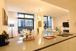 a kitchen and living room with a counter top at Manzil - Sleek 2BR nr Downtown & Dubai Mall in Dubai