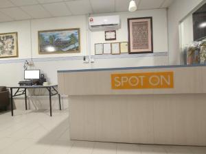 a store counter with a sign that says spot on at Amida Point in Kuching