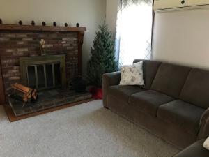 a living room with a couch and a fireplace at Missouri Holiday Homes LLC 