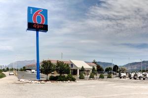 un cartello della stazione di servizio di fronte a un parcheggio di Motel 6-Ogden, UT - Riverdale a Ogden