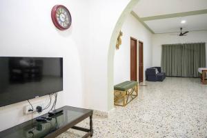 a living room with a flat screen tv on a wall at Tourist Friendly Home -3BHK AC Near Birla Mandir, Hyderabad in Hyderabad