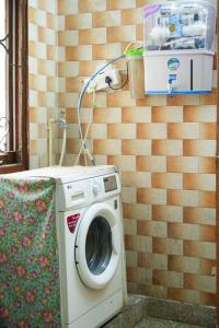a washing machine in a room with a wall at Tourist Friendly Home -3BHK AC Near Birla Mandir, Hyderabad in Hyderabad