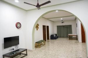 an archway in a living room with a flat screen tv at Tourist Friendly Home -3BHK AC Near Birla Mandir, Hyderabad in Hyderabad