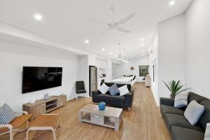 a living room with two couches and a tv at Evelyn @ Cape Villas, Dunsborough in Dunsborough