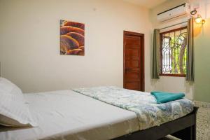 a bedroom with a bed and a stained glass window at Tourist Friendly Home -3BHK AC Near Birla Mandir, Hyderabad in Hyderabad