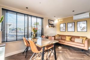 a living room with a table and a couch at Beautiful Water Villa, near Schiphol and Amsterdam in Aalsmeer