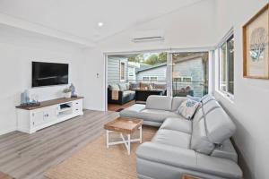 a living room with a couch and a tv at Willy Wagtail @ Cape Villas in Dunsborough