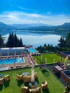 an outdoor pool with a view of a lake at Hotel Roser House Boutique - pe malul lacului Colibita in Colibiţa +95 photos