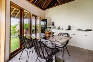 a kitchen with a table and chairs in a kitchen at Umani Village in Kerobokan