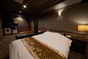 a room with a bed in a room with a lamp at ROOM袖ヶ浦 -Adult Only- in Sodegaura