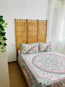 a bedroom with a bed with a quilt on it at Apartamento La Quinta in Cala del Moral