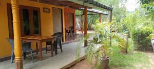 un portico di una casa con tavolo e pianta di The Nest a Mahiyangana