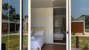two pictures of a bedroom with a bed and a balcony at Meraga Cinta Kijal in Kijal