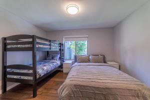 a bedroom with two bunk beds and a window at #521- Luxury Remodeled, Mid-Town Condo in Mammoth Lakes