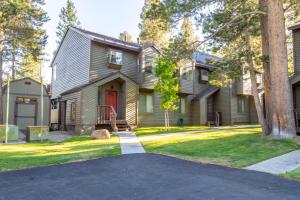 a house with a red door and a driveway at #521- Luxury Remodeled, Mid-Town Condo in Mammoth Lakes
