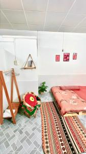 Homestay YẾN HÒA في Ấp Bình Hưng: غرفة نوم مع سرير وسجادة على الأرض
