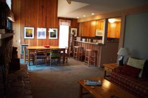 a living room and kitchen with a table and chairs at #278 Ski-in, Ski-out Corner unit with View in Mammoth Lakes