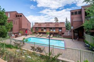 a swimming pool in a yard next to a building at #278 Ski-in, Ski-out Corner unit with View in Mammoth Lakes