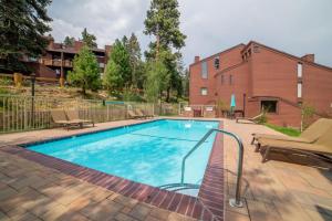 a swimming pool in a yard with a building at #381 - Ski-In Ski-Out Condo with Spa, Game Room, & Pool in Mammoth Lakes