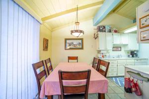 a dining room with a table and a kitchen at #469 - Pet-Friendly Mountain Condo, Pool & Spa in Mammoth Lakes