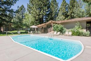 a swimming pool in front of a house at #469 - Pet-Friendly Mountain Condo, Pool & Spa in Mammoth Lakes