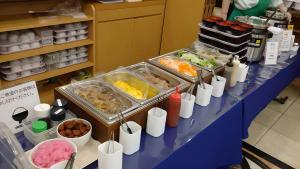 a buffet line with food on a blue table at Toyoko Inn Saitama Shintoshin in Saitama