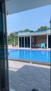 a view of a swimming pool from a house at Meraga Cinta Kijal in Kijal