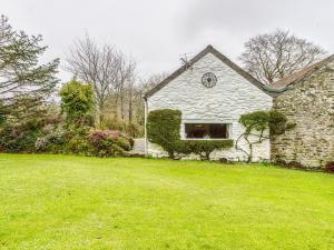 an old stone house with a window in a yard at Secluded Holiday Home in Ceredigion with Garden in Pennant