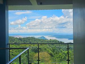 a room with a window looking out at a lake at Casa Noah in Tagaytay