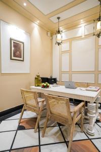a dining room with a white table and chairs at Dev Mahal - A Boutique Heritage Hotel in Jaipur